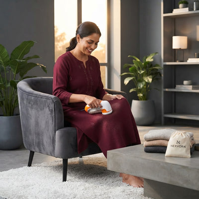 A woman using a lint remover on a woolen kurta in a modern living room setting.